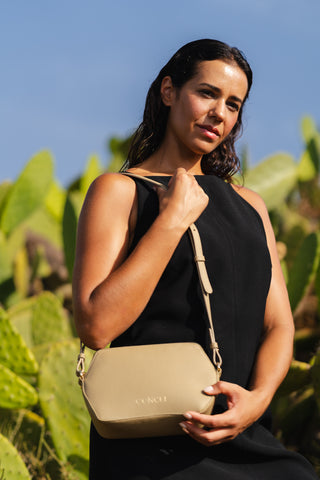 Model is cactus field wearing the Coneli Fanny Pack in color beige as shoulder bag