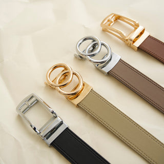 four belts with different buckles on a light background